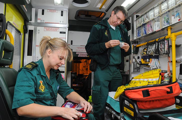 Ambulance crew prepare for night out on shift in the back of their ambulance